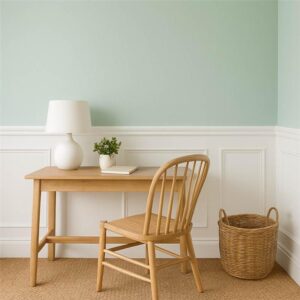 Mint wall with white panelling and woven jute rug—light, calming space